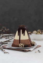 Festive Easter dessert of cottage cheese and three types of white, milk and bitter chocolate on a...