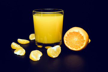 A glass of freshly squeezed tangerine juice and tangerine