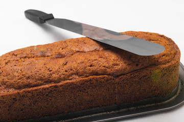 Carrot cake freshly brewed and a knife to serve it in an oven tray