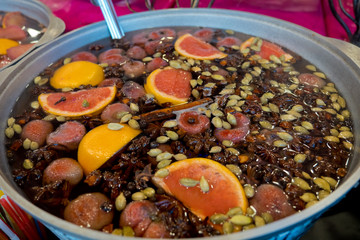 Mulled wine in a large cauldron. Vitamins in the winter festival.
