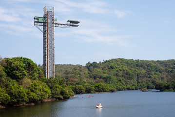 Long exposure Landscape image of Mayem Lake in Goa with the bungee jumping structure on display, Jumpin heights bungee jumping landscape view in Goa, Boat peddling in Goa