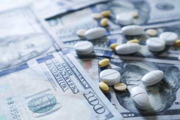medicine pill on 100 dollar banknote background.Healthcare insurance and medical treatment cost concept