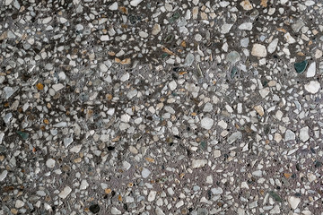 background concrete slab with small stones of different colors and sizes