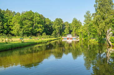 Picturesque pond in  park with  gazebo on  shore