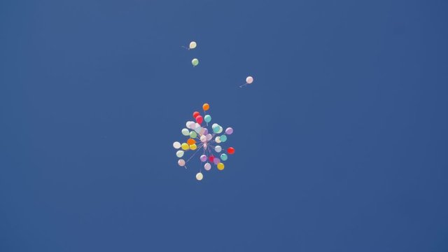 Bunch of balloons flying in blue sky. Colorful air balloons against blue sky. Celebration concept