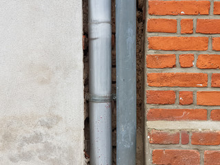 Background texture of stone wall made of bricks and a gutter