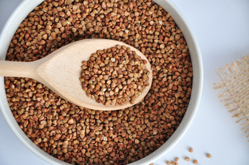 buckwheat on a plate and spoon isolated background