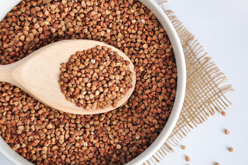buckwheat on a plate and spoon isolated background