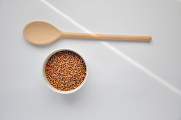 buckwheat on a plate and spoon isolated background
