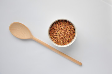 buckwheat on a plate and spoon isolated background