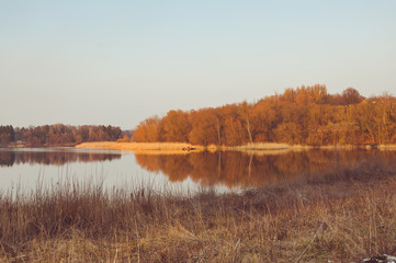 Beautiful colorful sunset over a forest lake