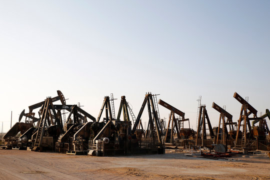 Old oil pump jacks at a scrap yard, Oman