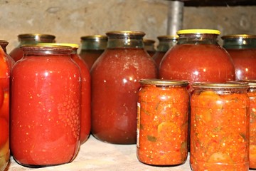In glass jars, rustic canned delicious vegetables prepared by grandmother for the winter