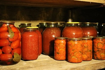 In glass jars, rustic canned delicious vegetables prepared by grandmother for the winter