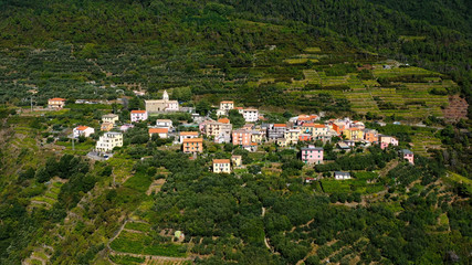 Fototapeta na wymiar Riomaggiore Cinque Terre is a traditional and colorful fishing village near a cliff on the Mediterranean Sea, located on the Ligurian coast in Italy. 