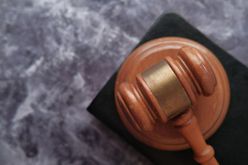  top view of gavel on a book on wooden table 