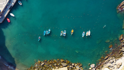 Fototapeta na wymiar Aerial Drone View of Boats in Vernazza Cinque Terre, Italy. Perfect for leisure vacations near the Mediterranean Sea