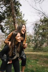 Two twin sisters having fun in the park