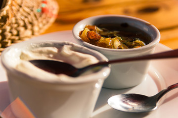 Ukraine fried fat and onion with sour cream in restaunrant in Lviv. Close up shoot of food. Traditional meal in  restaurant. Rustic eating. Yellow and white colors. National dish. Nobody. Indoor.