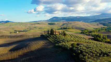 Fototapeta na wymiar Panorama of a landscape with meadows in Tuscany Italy, with mountain in the background, aerial view