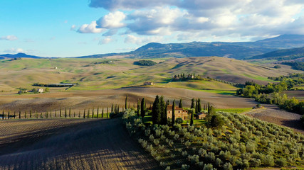 Obraz premium Panorama of a landscape with meadows in Tuscany Italy, with mountain in the background, aerial view