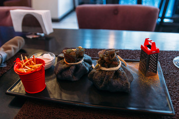 Ukraine black panecake in restaunrant in Lviv. Close up shoot of food. Traditional meal in restaurant. Rustic eating. Ukrainian tasty meal. National dish. Nobody. Travel. Slavic tasty food in cafe.