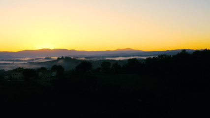 Beautiful landscape scenery of Tuscany in Italy - sunrise with fog in aerial view 