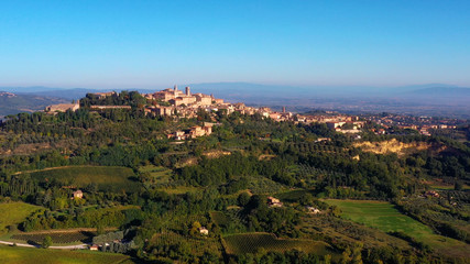 Fototapeta na wymiar Authentic village of Montepulciano. A beautiful old town with red roofs in Tuscany, Italy. Perfect for travels and vacations - aerial view with a drone 