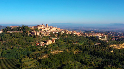 Fototapeta premium Authentic village of Montepulciano. A beautiful old town with red roofs in Tuscany, Italy. Perfect for travels and vacations - aerial view with a drone 