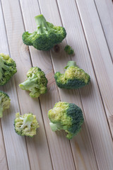 green healthy broccoli on light wood