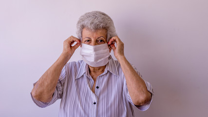 Elderly woman wearing protective mask against corona virus