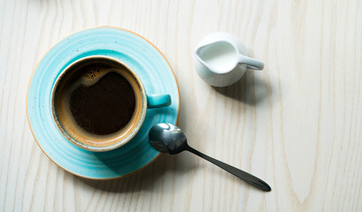 cup of coffee for milk and a spoon on the table