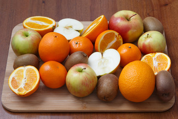 fruit diversity on a wooden kitchen Board made of sliced and whole fruits