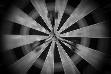 Motion Blur on a Dartboard with Three Darts in the Bull's Eye - Black and White