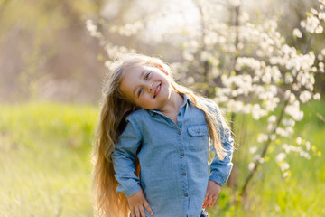 Little girl with beautiful thick hair has fun in the park.