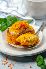 Traditional carrot cake with cream and crumbs.