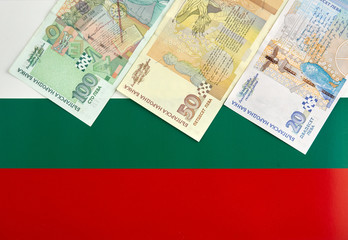 Bulgarian banknotes in front of  Bulgarian flag