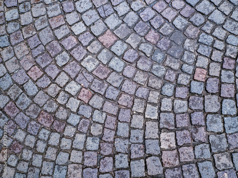 Poster the old stone pavement is lined with the same square blocks in an arc. cobblestones lie at a certain