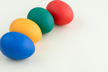 four easter eggs of different colors  lay in raw, space or text, greetings card, easter holidays concept