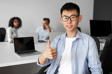 Asian trainee approving work in office