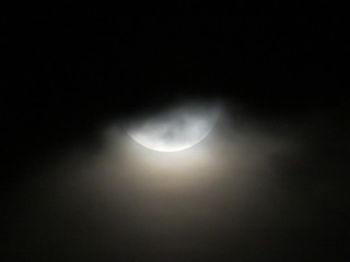 Obraz na płótnie Canvas Part of the moon behind the clouds