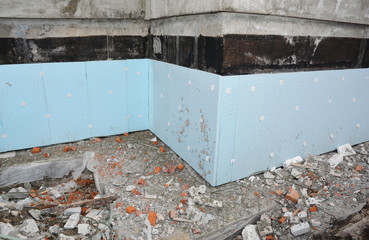 House foundation insulation with styrofoam insulation boards and  spray on bitumen waterproofing on foundation wall