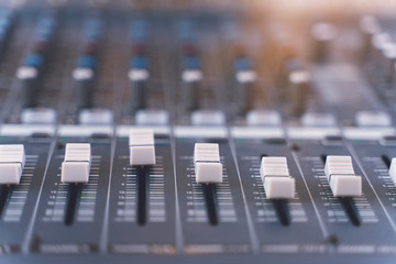 Sound mixer. Professional audio mixing console with lights, buttons, faders and sliders.
