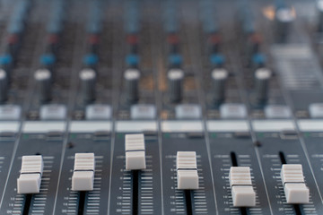 Sound mixer. Professional audio mixing console with lights, buttons, faders and sliders.