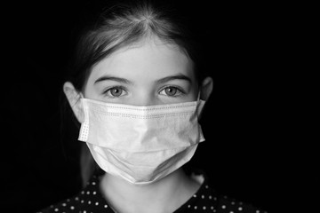 Young girl in a protective medical mask. epidemic in China, Italy, Europe. Flu, pneumonia, coronavirus concept. Portrait on a dark background