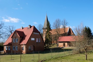 Obraz premium Historic brick church and presbytery in the village of Huta Kalna, Bory Tucholskie, Poland