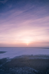 Fototapeta premium Sun through fog at lake winter morning