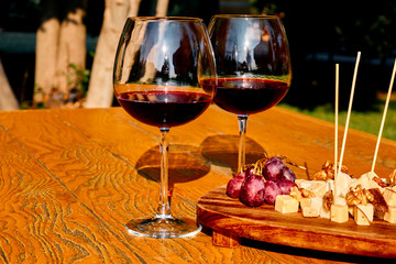 Glasses Of Fine Red Wine With Grape and cheese