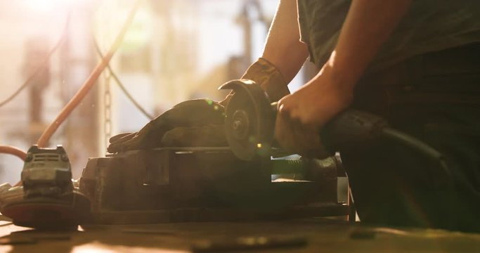 Bladesmith deburring metal with angle grinder