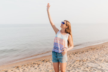 Image of a gorgeous young woman posing outdoors on a sea beach